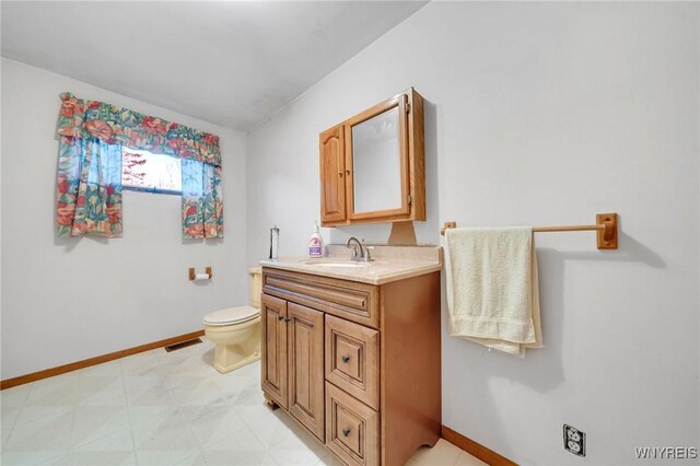 bathroom with visible vents, baseboards, toilet, and vanity