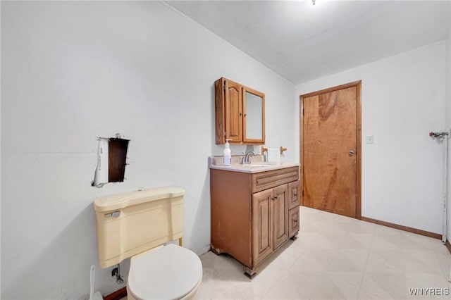 bathroom with tile patterned floors, baseboards, toilet, and vanity