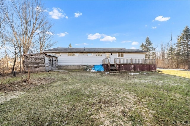 back of property featuring a lawn and a wooden deck