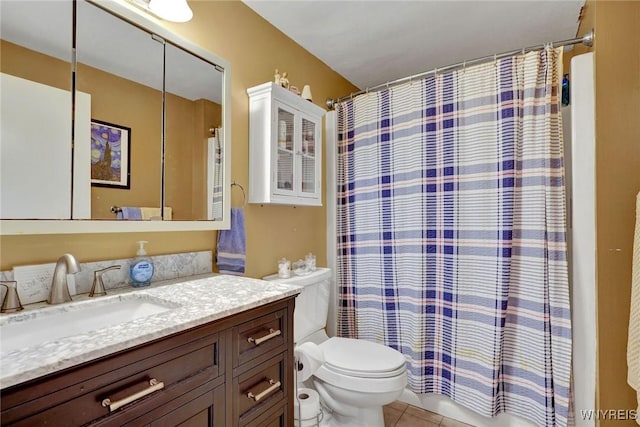 bathroom with tile patterned floors, shower / bath combo with shower curtain, toilet, and vanity