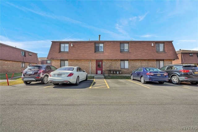 view of building exterior featuring uncovered parking