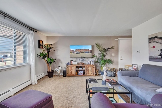 living room with a baseboard heating unit, baseboards, and carpet floors