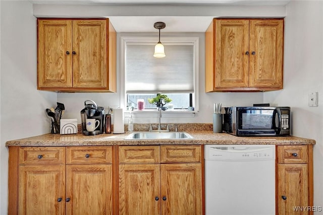 kitchen featuring black microwave, pendant lighting, light countertops, white dishwasher, and a sink