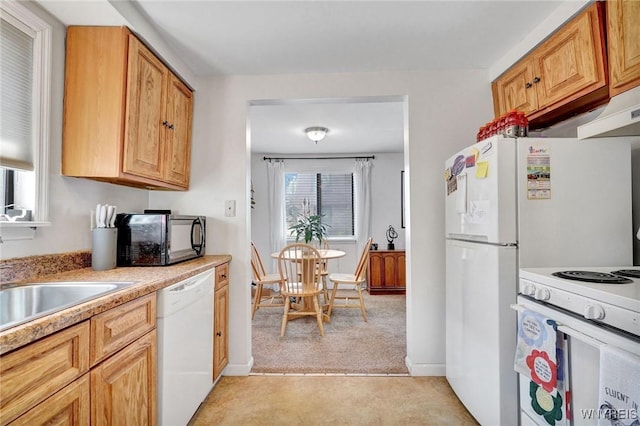 kitchen with light countertops, baseboards, white dishwasher, and light carpet