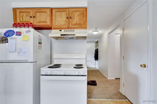 kitchen featuring under cabinet range hood, baseboards, white appliances, and light carpet