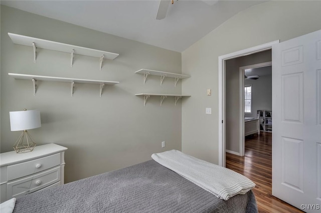 bedroom featuring dark wood-type flooring, a ceiling fan, and lofted ceiling