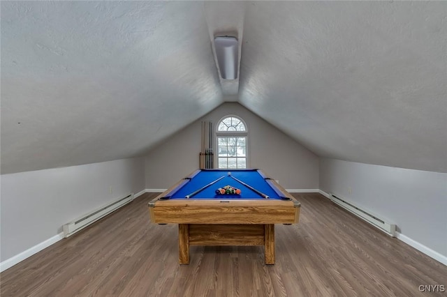 playroom featuring a baseboard heating unit, lofted ceiling, and wood finished floors