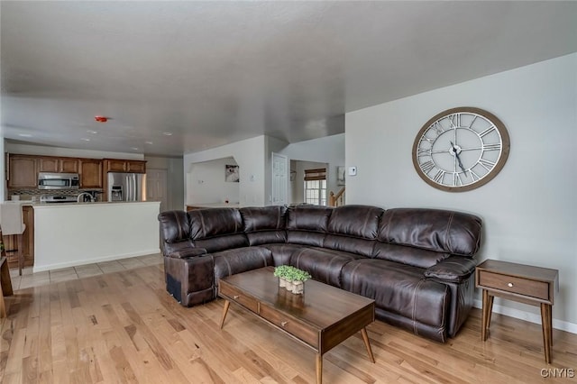 living room featuring baseboards and light wood-style floors