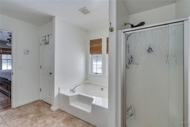 ensuite bathroom with visible vents, baseboards, a garden tub, a stall shower, and ensuite bath