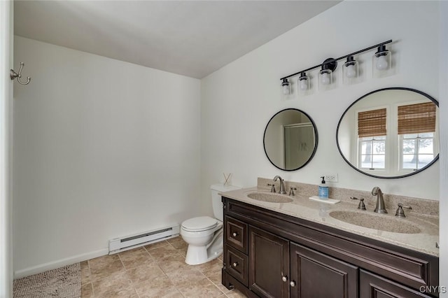 full bath with double vanity, a sink, toilet, and a baseboard radiator