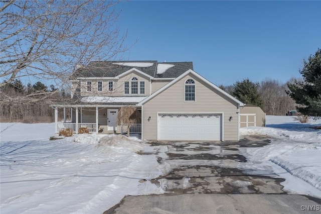 view of front facade with an attached garage, covered porch, and driveway