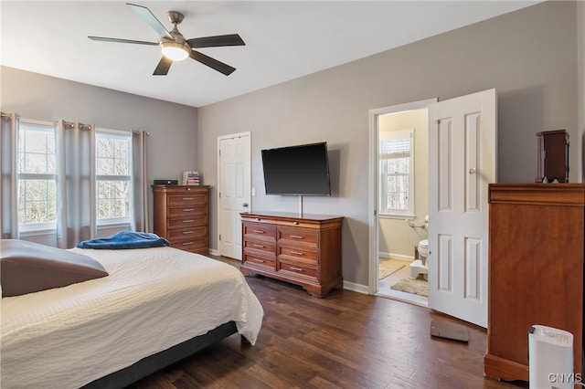 bedroom featuring connected bathroom, a ceiling fan, dark wood-type flooring, and baseboards