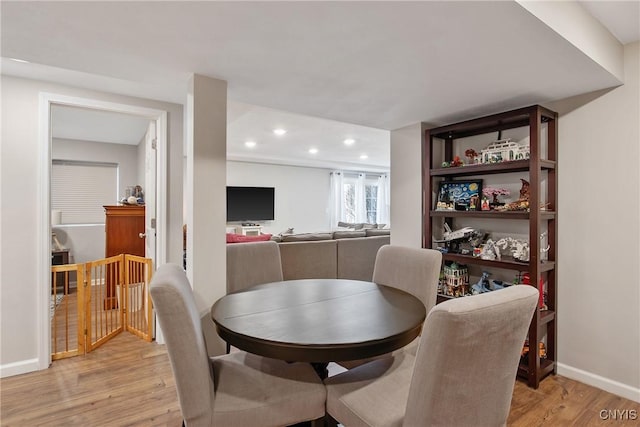 dining room with recessed lighting, baseboards, and light wood-style floors