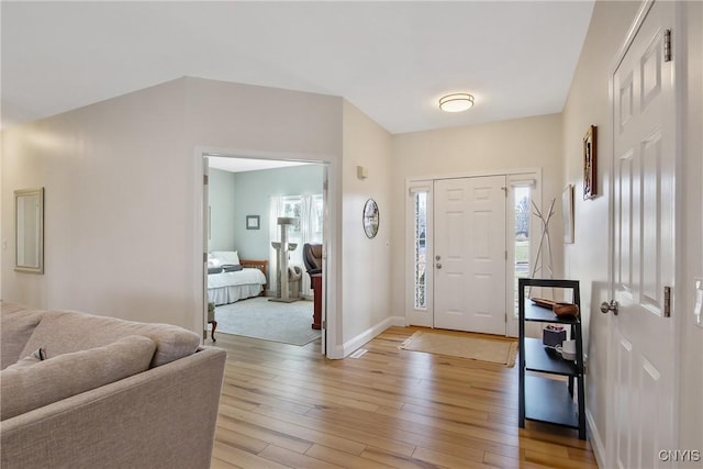 entrance foyer with light wood finished floors and baseboards