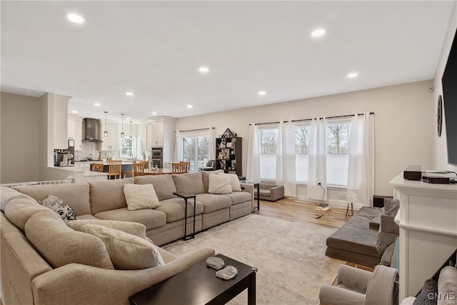 living room with recessed lighting and light wood-type flooring