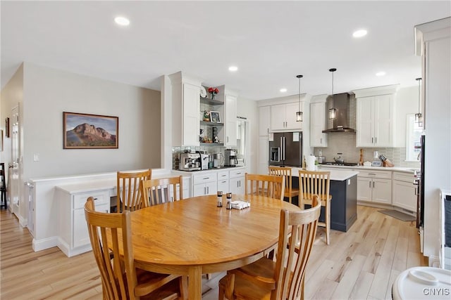 dining room with light wood finished floors and recessed lighting