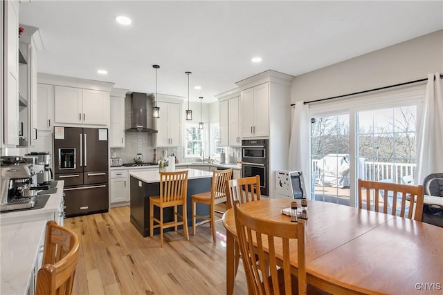 dining room featuring recessed lighting and light wood-type flooring