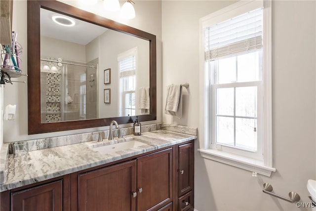 full bath featuring a stall shower and vanity