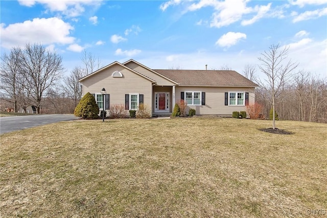 ranch-style house with driveway and a front yard