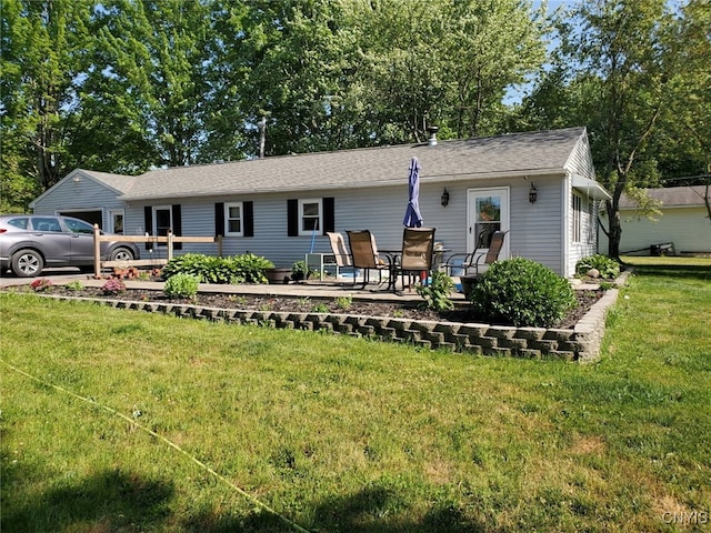 rear view of property with a yard