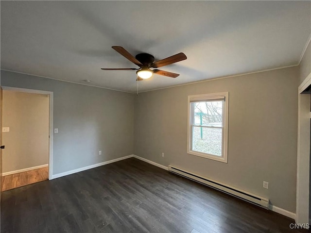 spare room featuring a ceiling fan, dark wood-style floors, baseboards, crown molding, and baseboard heating