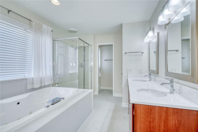 full bath featuring a sink, a jetted tub, a shower stall, and double vanity