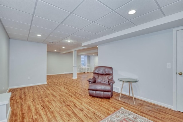 sitting room featuring recessed lighting, a drop ceiling, baseboards, and wood finished floors