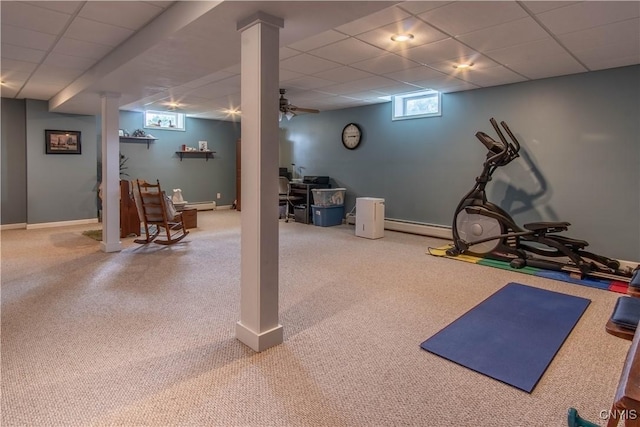 workout room featuring a paneled ceiling and baseboards