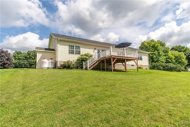 rear view of house featuring crawl space, a yard, a wooden deck, and stairway