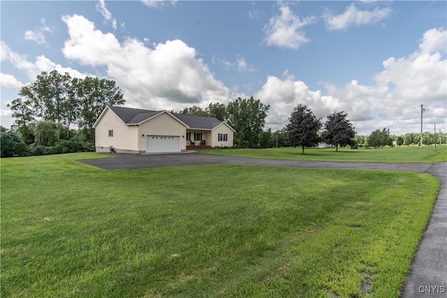 ranch-style house featuring a front lawn, an attached garage, and driveway