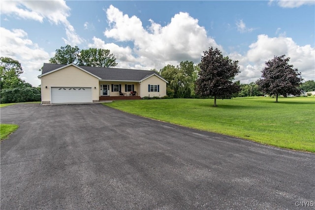 ranch-style house with a front lawn, an attached garage, covered porch, and driveway