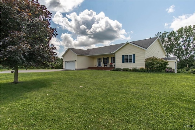 ranch-style home with a front yard, an attached garage, and driveway