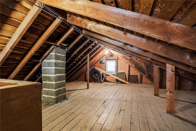 unfinished attic featuring an upstairs landing