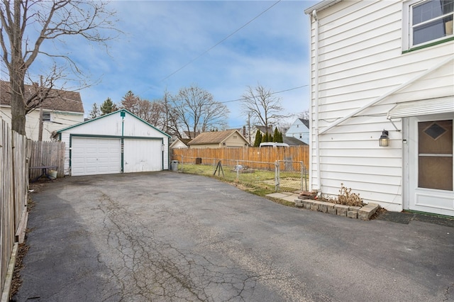 detached garage featuring fence