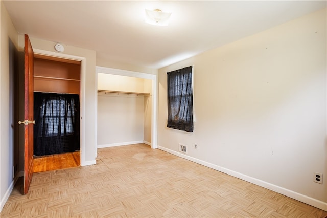 unfurnished bedroom featuring a closet, baseboards, and visible vents