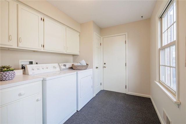 laundry area featuring visible vents, baseboards, cabinet space, dark colored carpet, and separate washer and dryer