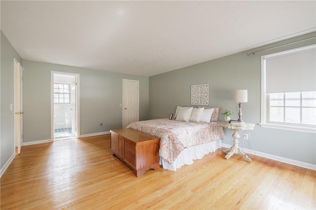 bedroom with baseboards and light wood-style flooring