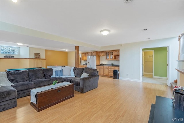 living room featuring baseboards and light wood-style floors