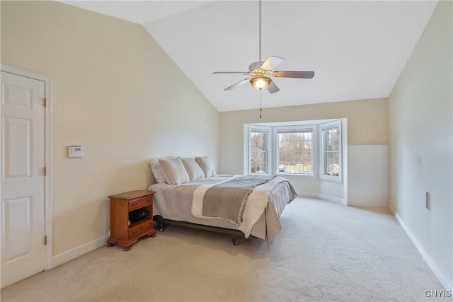 bedroom featuring a ceiling fan, lofted ceiling, light colored carpet, and baseboards