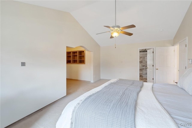 bedroom featuring a walk in closet, light carpet, a ceiling fan, a closet, and lofted ceiling