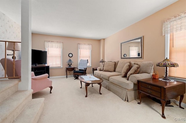 living area featuring carpet flooring and baseboards