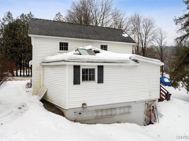 exterior space featuring a shingled roof