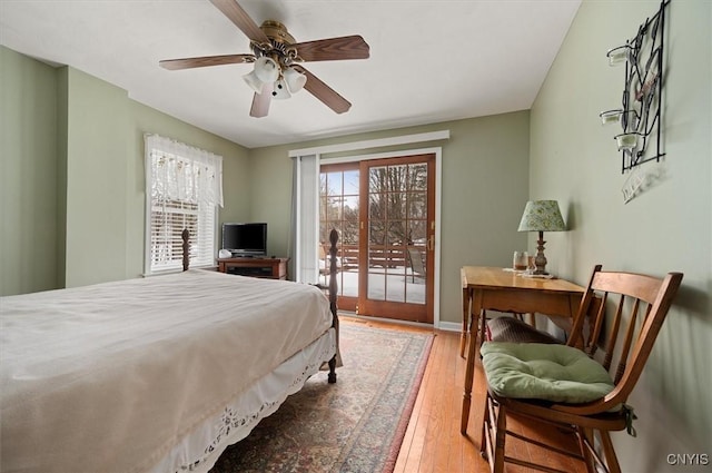 bedroom with wood-type flooring, a ceiling fan, and access to outside