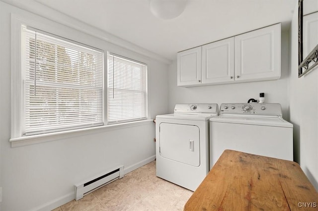 washroom with a baseboard heating unit, baseboards, washer and clothes dryer, light tile patterned floors, and cabinet space