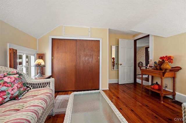 entryway featuring a textured ceiling, baseboards, and wood finished floors