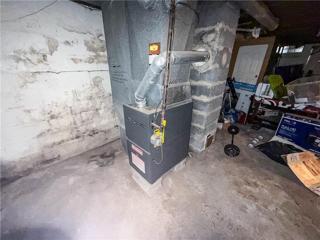 utility room featuring heating unit