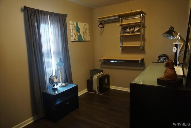 interior space featuring baseboards and dark wood-type flooring