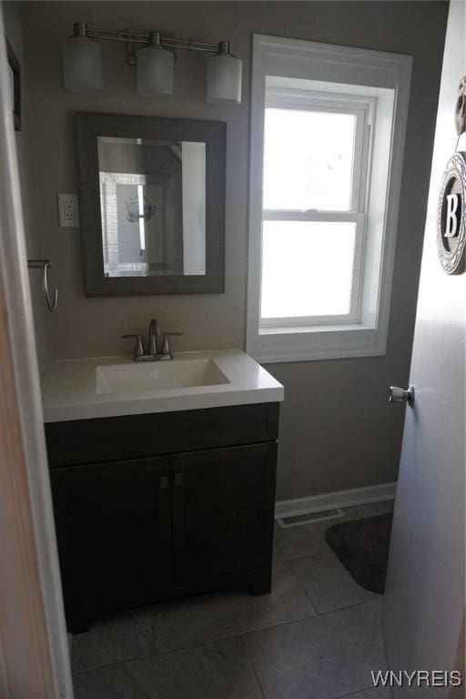 bathroom featuring baseboards, vanity, and tile patterned flooring