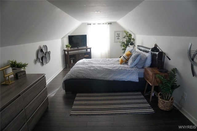 bedroom featuring dark wood finished floors, vaulted ceiling, and baseboards