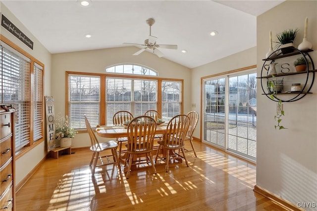 dining area with plenty of natural light, light wood-style flooring, and vaulted ceiling